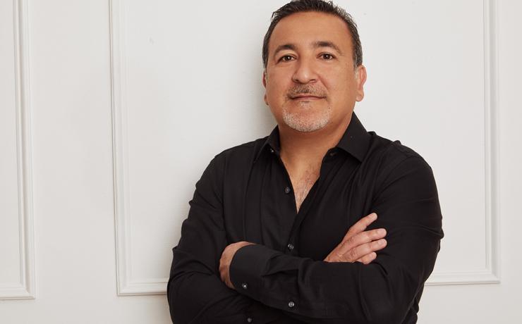 Owner Shy Dayan dressed in black with crossed arms